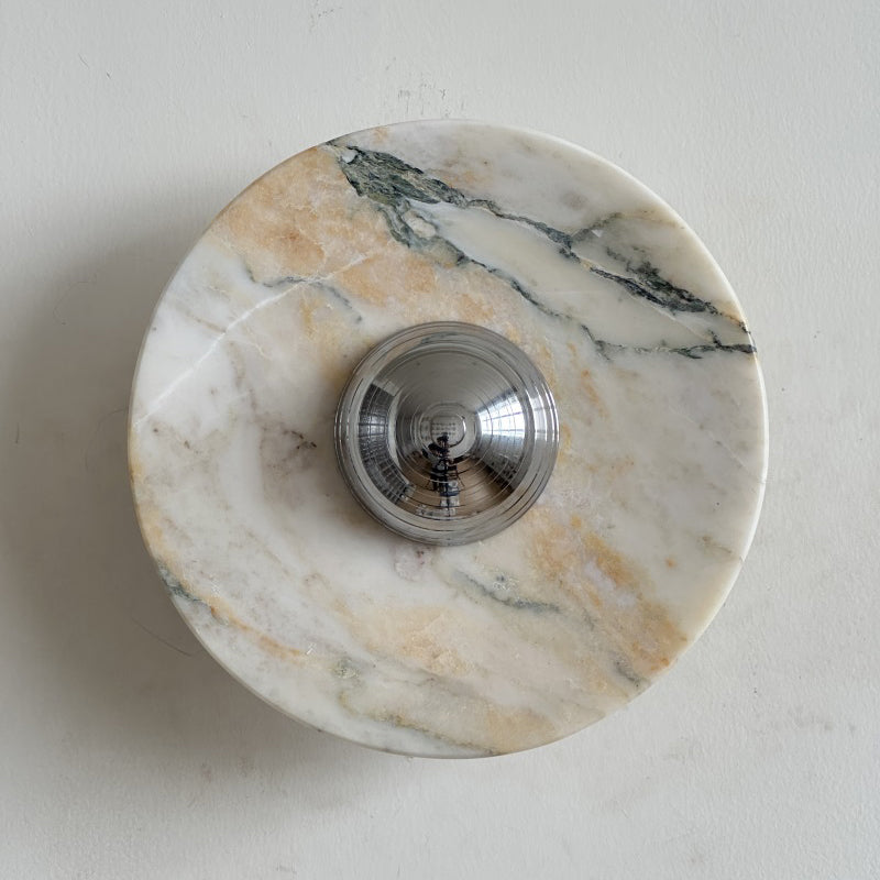 Fine, brushed purple-grey streaks run across the pale disc of this Clérachic marble wall light, with a chrome dome at its centre.