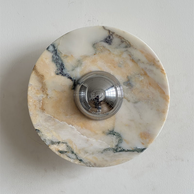 Long grey veins and soft gold hints cross the white stone of this Clérachic marble wall light, around its chrome dome.