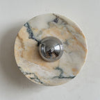 Long grey veins and soft gold hints cross the white stone of this Clérachic marble wall light, around its chrome dome.