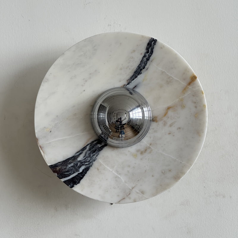 A thick dark vein runs down the right side of this Clérachic marble wall light, with brown flecks near its chrome centre.