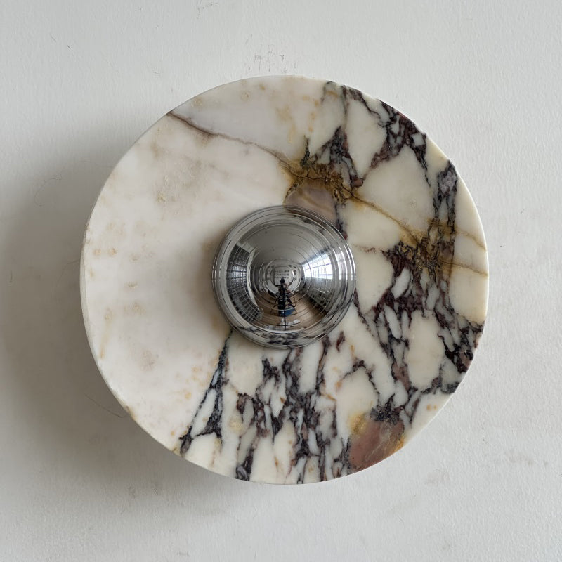 Clean cream stone with a web of black and gold veins spreads out from the chrome dome of this Clérachic marble wall light.