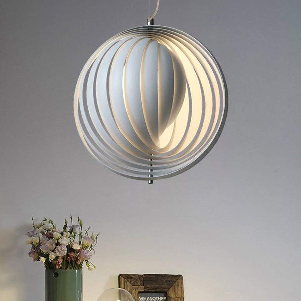 The Clérachic Round Metal Pendant Light hangs above a green vase of pink flowers, warm light between white slats.