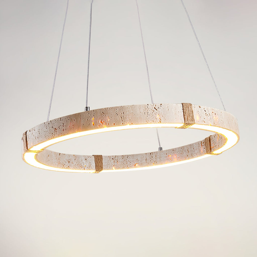 Close view of the lit travertine ring from Clérachic, showing the pitted stone and glowing inner edge, with fine cables above.