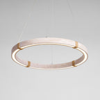 The pale travertine Clérachic ring pendant lit, with a warm glow along the inner edge and four rope-wrapped joints.