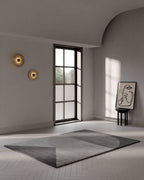 Two Clérachic round alabaster sconces on a white wall in a room with a herringbone floor.