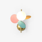Round frosted glass globe with pink, mint and orange metal discs on a brass stem and dome backplate, this Clérachic wall light in the multicolour finish.
