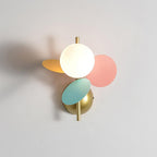 Multicolour Clérachic wall light on a pale grey wall, the lit glass globe framed by pink, mint-green and orange discs.