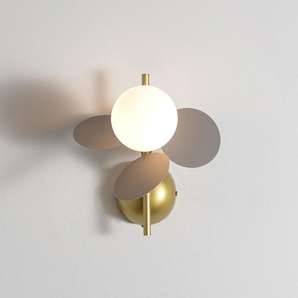Grey version of this Clérachic wall light, three soft grey-brown discs around a glowing globe, with a brass stem and dome mount.