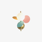 Frosted globe and pastel pink, mint and orange discs on a brass stem, shown as a Clérachic product shot on a plain off-white backdrop.