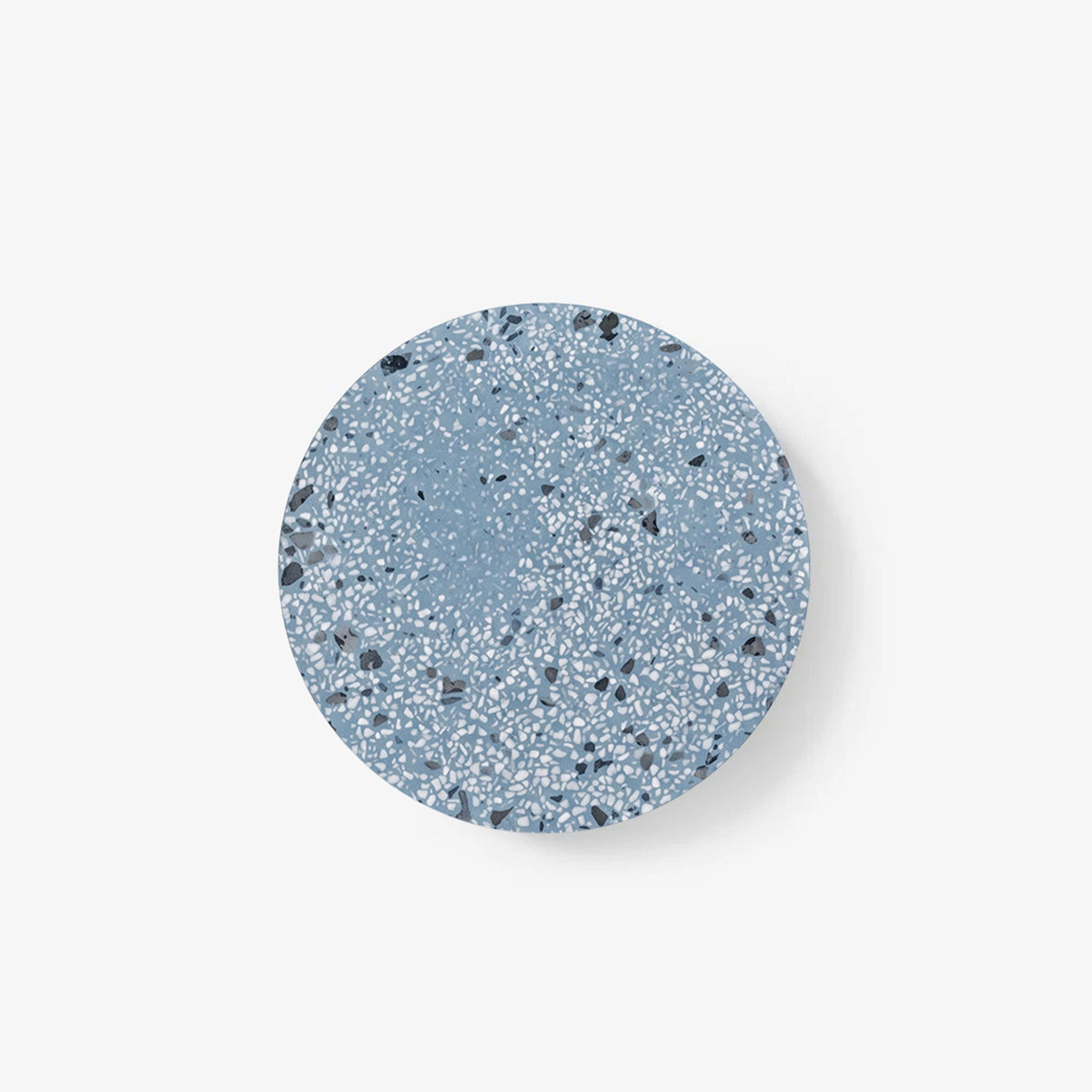 A Clérachic round wall light with a blue terrazzo face flecked in white and grey, on a plain white backdrop.