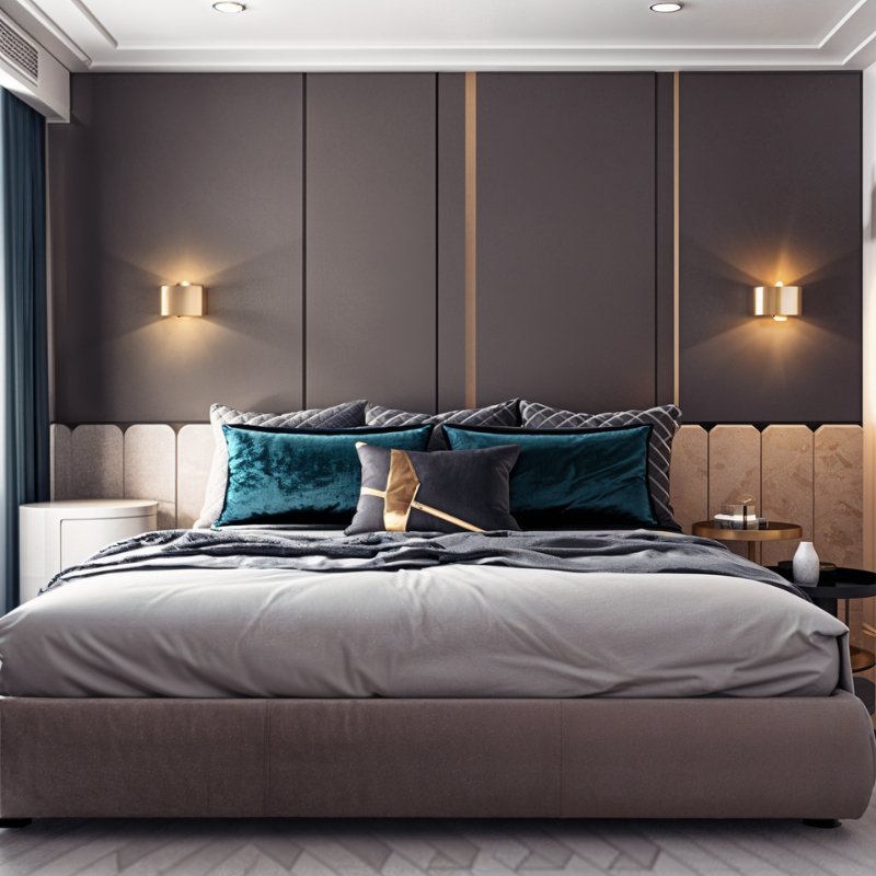 Clérachic pair of gold drum wall lamps glowing either side of a headboard on grey panelled bedroom wall above teal cushions.