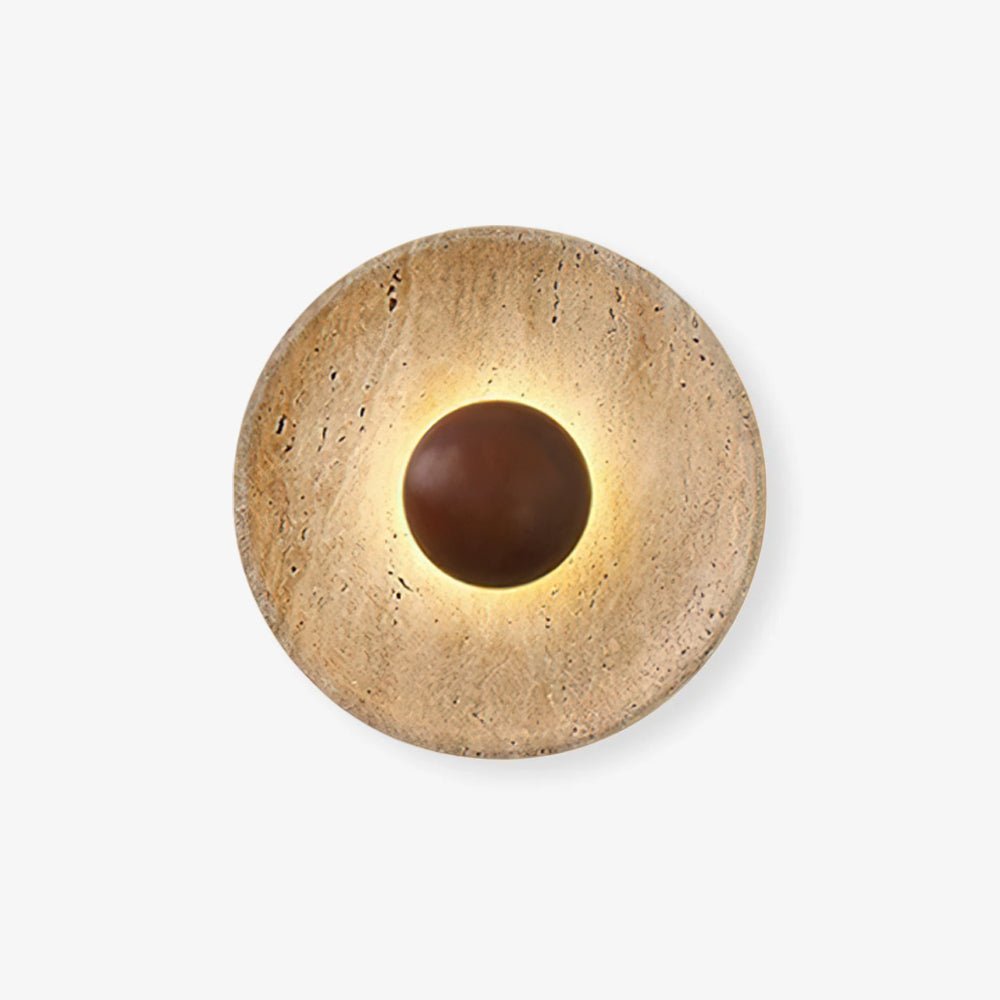 Front view of a Clérachic travertine wall light on white, with a rich walnut dome in its centre and a soft ring of warm light.