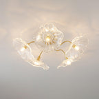 Five clear glass ruffled flowers on brass gooseneck arms make up this Clérachic ceiling light, each shade lit from within.