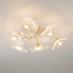 Clérachic's ceiling light in clear glass, its pressed flower shades angled up, down and outward from a brass canopy.