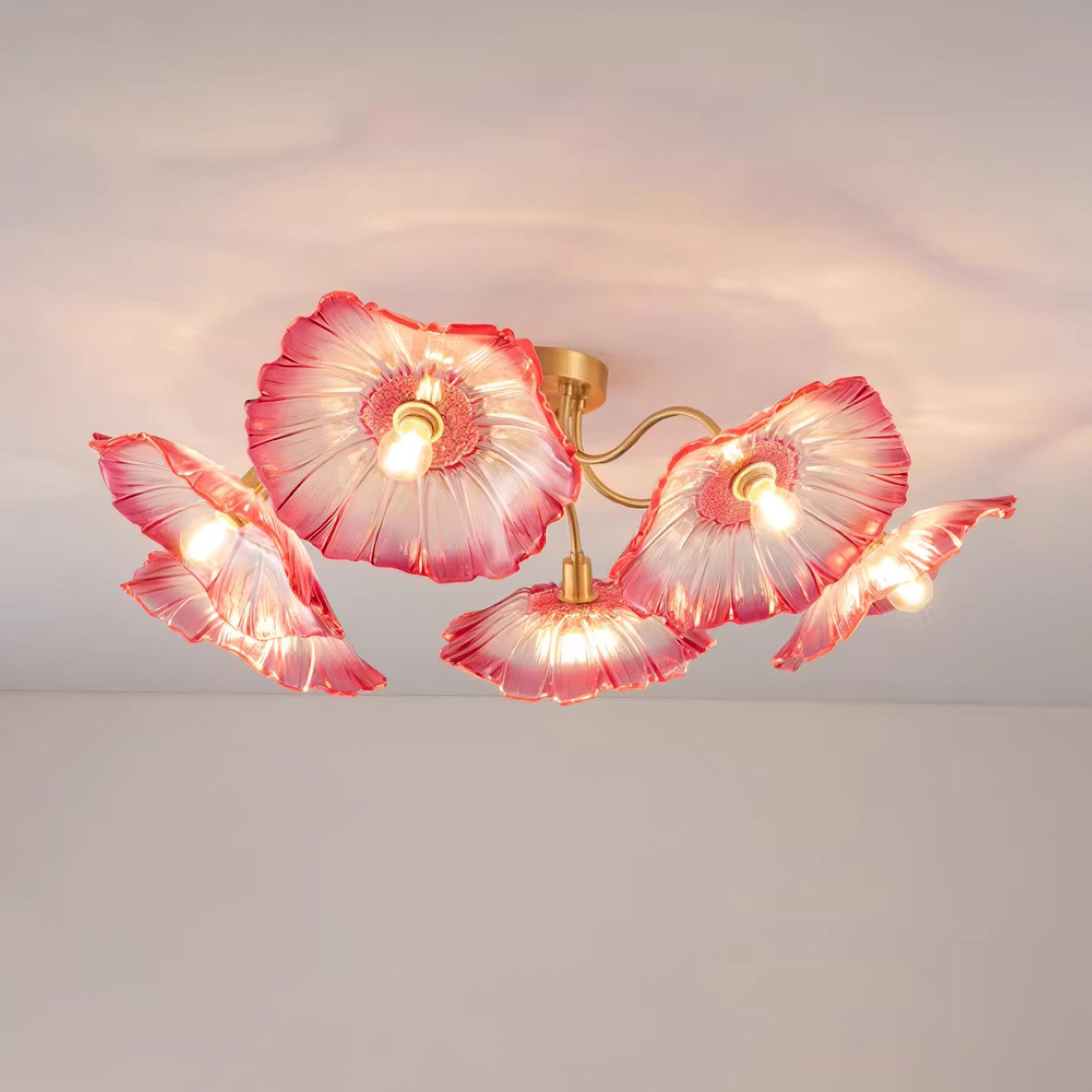 In pink glass, this Clérachic ceiling light fans its ruffled flower shades outward from a brushed brass canopy.