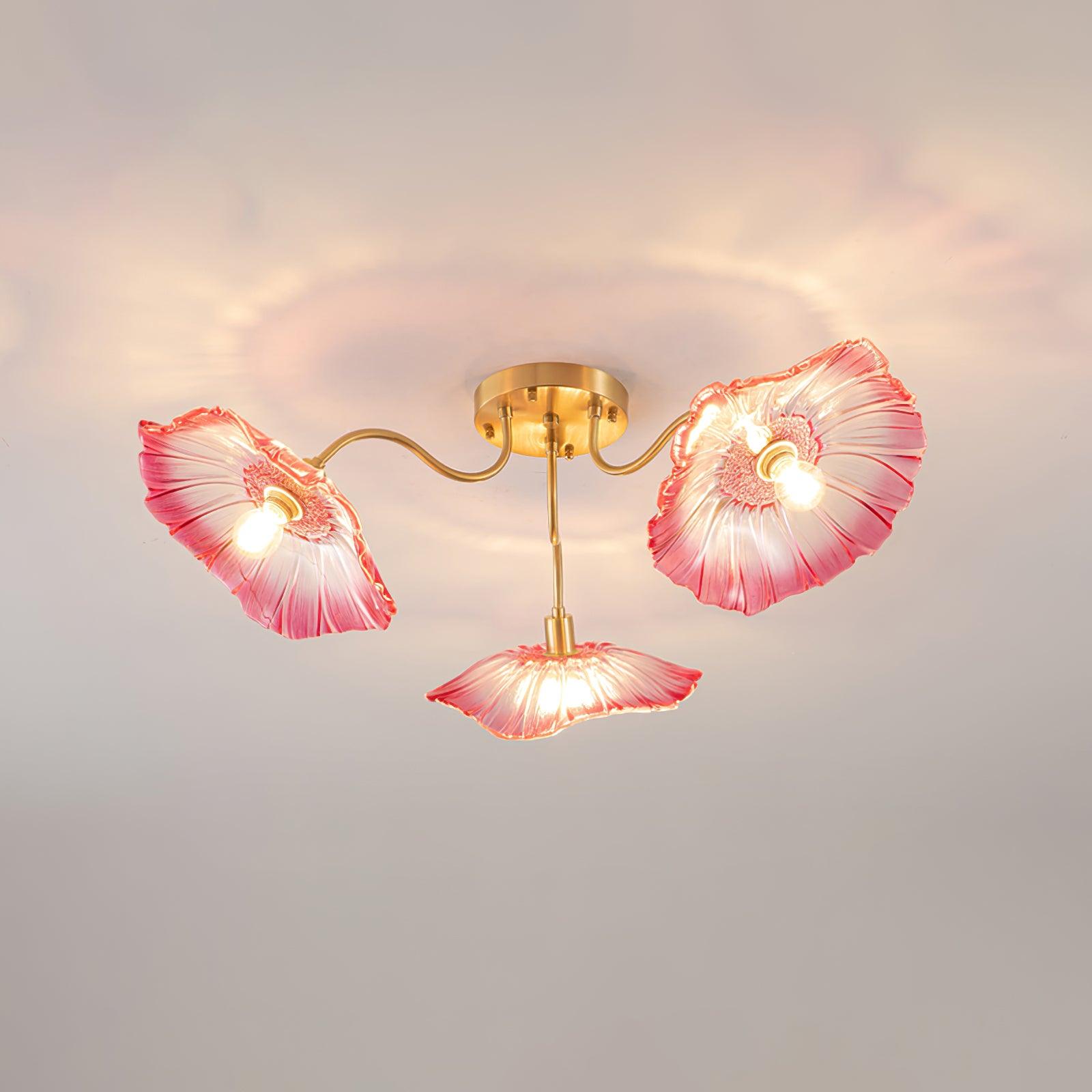 Three pink glass flowers form this Clérachic ceiling light, each shade rimmed in deep rose over a lit centre.