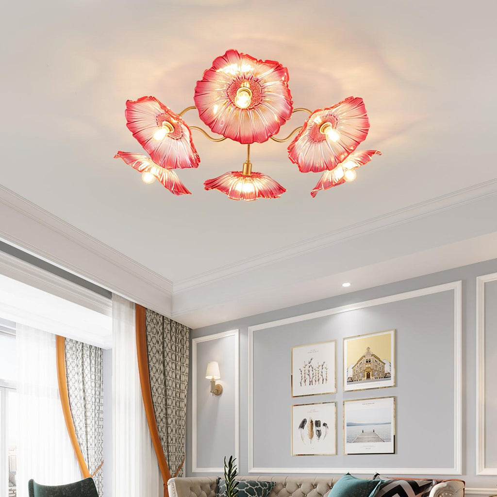 The pink glass Clérachic ceiling light glows above a tufted cream sofa in a gallery-wall living room.