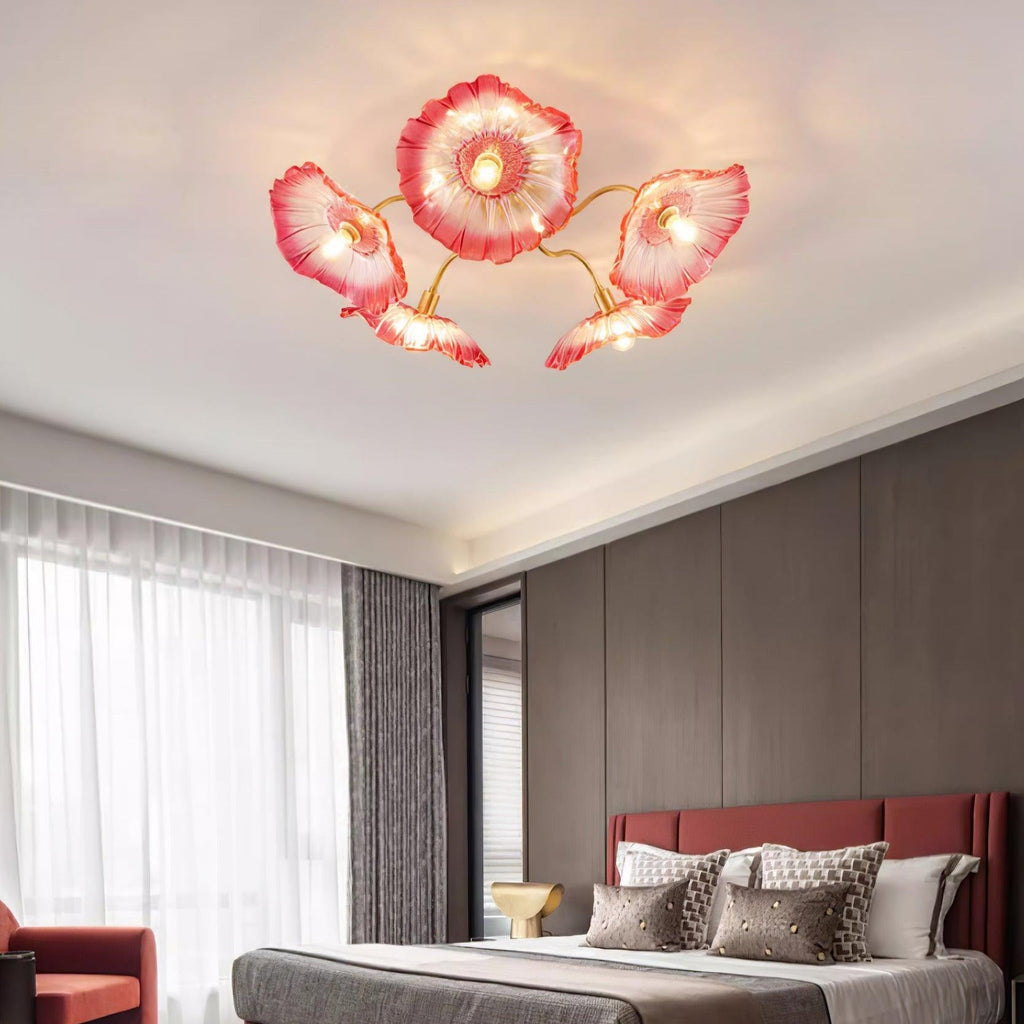 In pink glass, this Clérachic ceiling light warms a bedroom with a dark wood accent wall behind the bed.