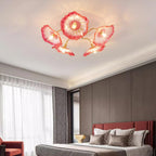 In pink glass, this Clérachic ceiling light warms a bedroom with a dark wood accent wall behind the bed.