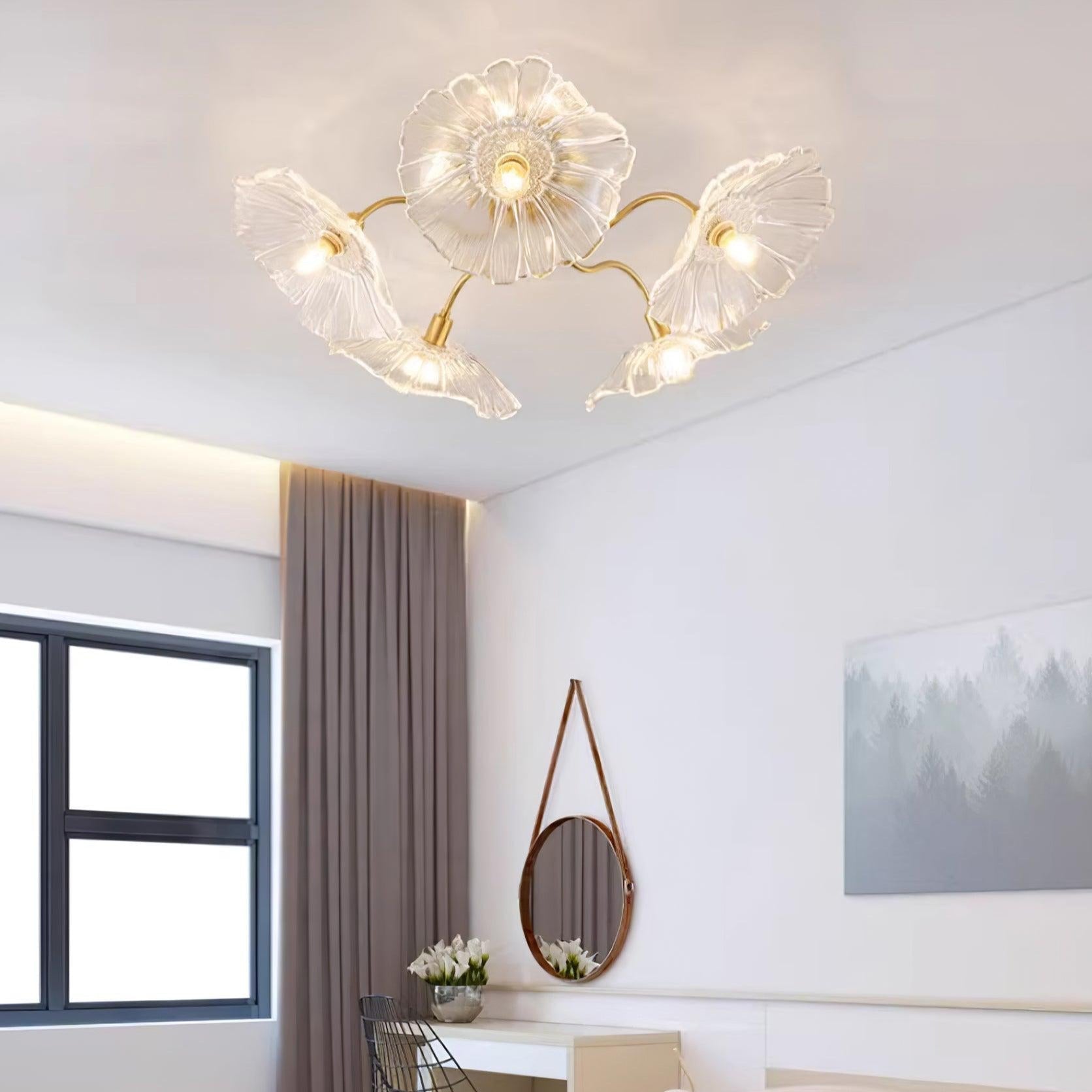 Clérachic's clear glass ceiling light lights a bedroom with taupe curtains and a round leather-strap mirror.