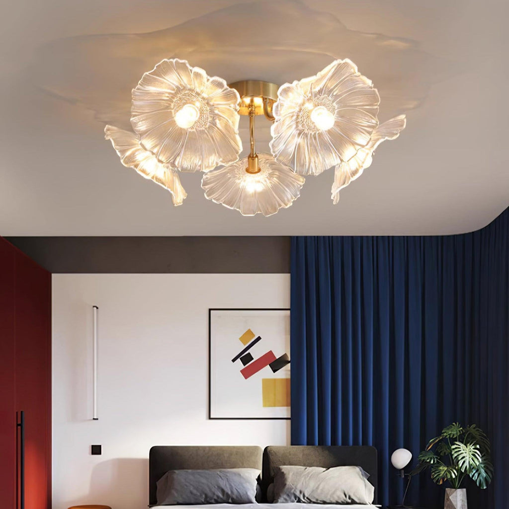 The clear glass Clérachic ceiling light glows over a dark upholstered bed in a navy-curtained bedroom.