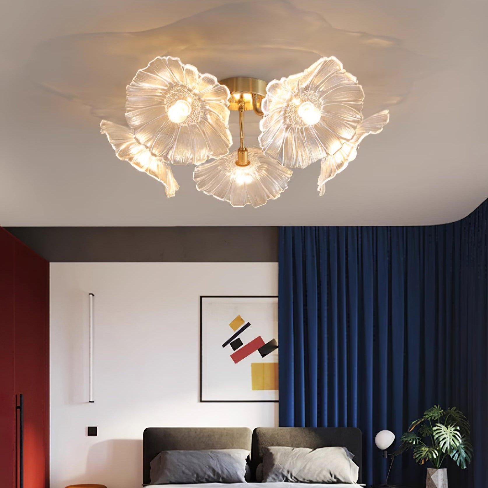 The clear glass Clérachic ceiling light glows over a dark upholstered bed in a navy-curtained bedroom.