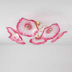 Studio shot of the Clérachic pink glass ceiling light isolated on white, its five ruffled shades fully lit.