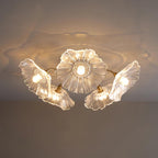 A dramatically lit clear glass Clérachic ceiling light casts a soft shadow across the ceiling above it.