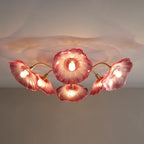 The pink glass version of Clérachic's ceiling light, dramatically lit with its shadow spreading across the ceiling.