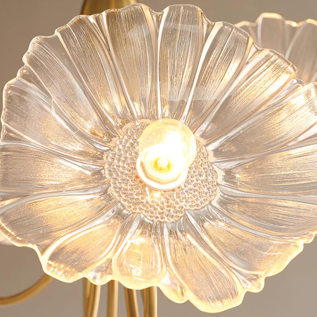 Close-up of a single clear glass flower shade on the Clérachic ceiling light, showing its ribbed petals and beaded centre.