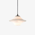 The Clérachic saucer pendant on white, its broad stone shade lit softly from within.