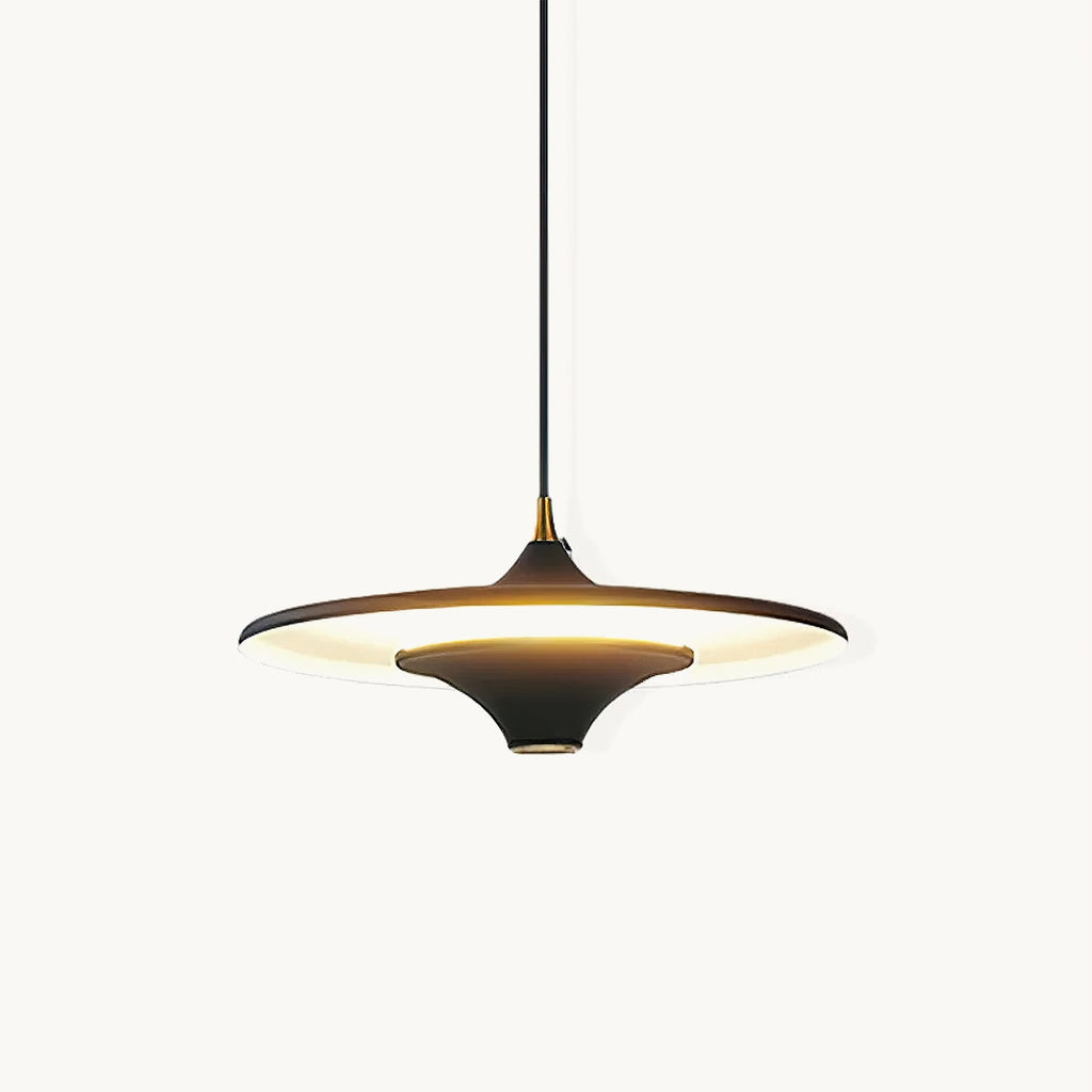 Black saucer-shaped Clérachic pendant with a brass collar, lit from beneath on a plain white backdrop.