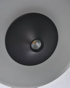 Close view of the recessed LED spot at the centre of the black cone on this Clérachic pendant.