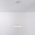 White Clérachic saucer pendant on a thin white cord from a white ceiling canopy, glowing softly against a grey wall.