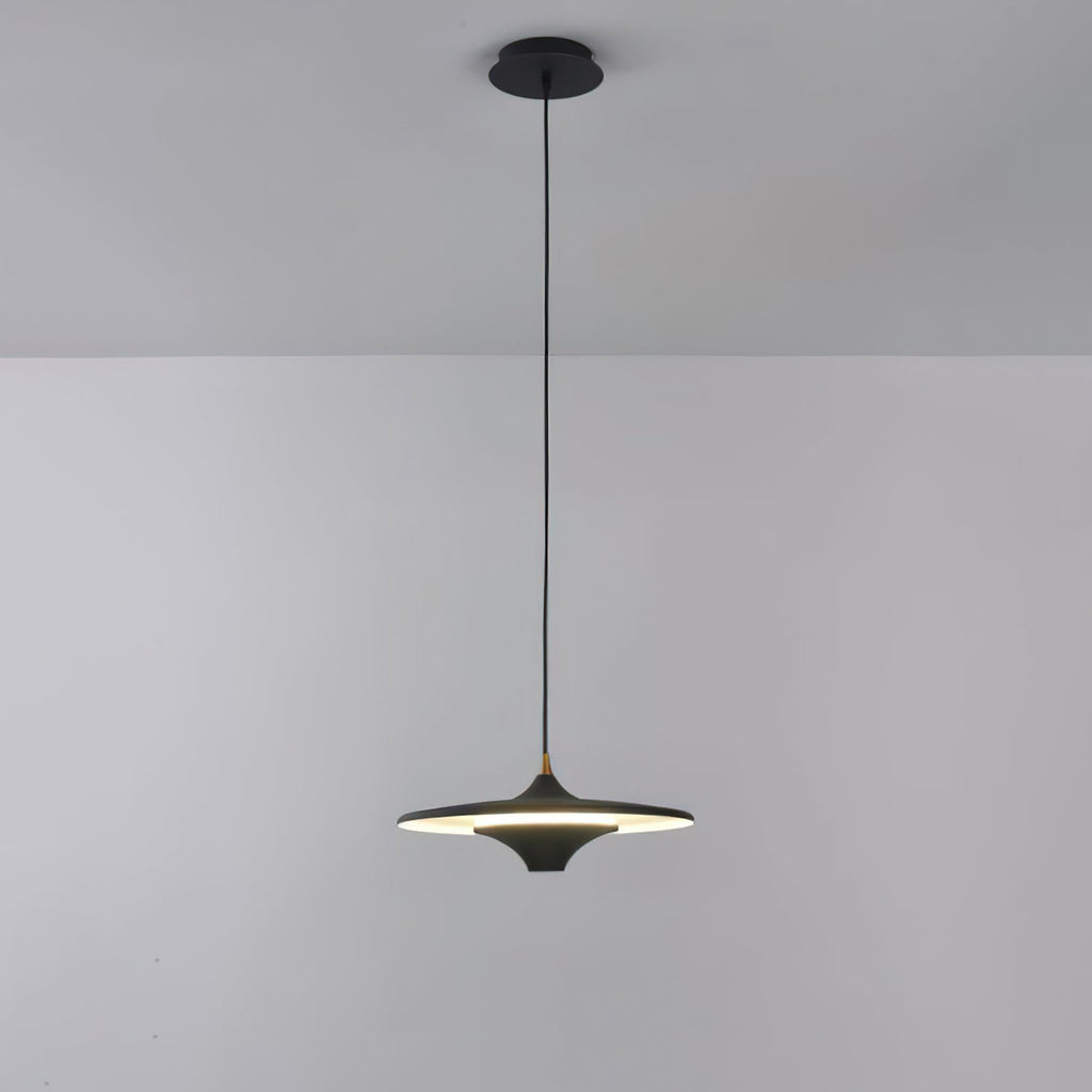 Black Clérachic saucer pendant lit, hanging on a black cord from a black canopy against a pale grey wall.