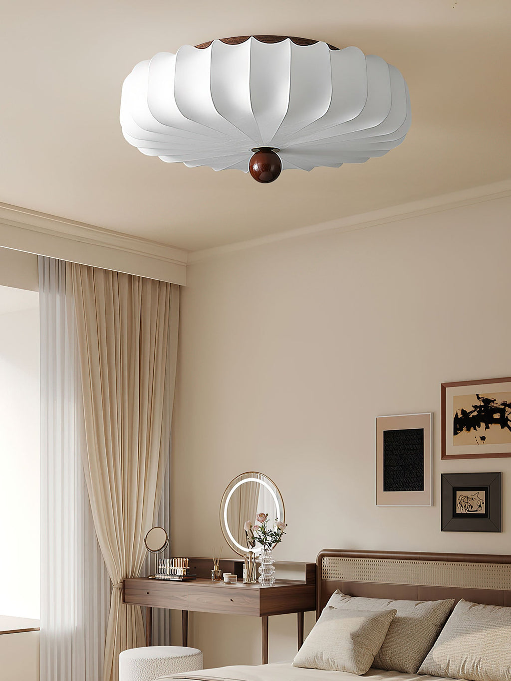 An unlit Clérachic ceiling light with a crisp white shade and wooden ball finial, in a bedroom with a dressing table and a round mirror.