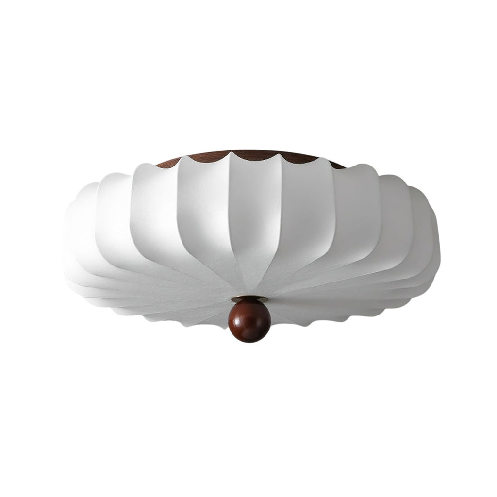 Side-on view of this Clérachic ceiling light on white, showing the shallow stacked shade and the wooden ball at its centre.