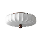 Side-on view of this Clérachic ceiling light on white, showing the shallow stacked shade and the wooden ball at its centre.