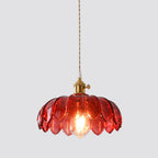 Studio view of the Clérachic Scalloped Flower Glass Pendant Light in red glass, hung on a braided flex from a brass holder.