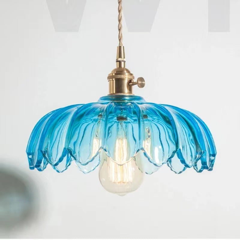 Clérachic Scalloped Flower Glass Pendant Light in blue glass, the ribbed petals catching the light above a soft grey interior.