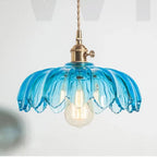 Clérachic Scalloped Flower Glass Pendant Light in blue glass, the ribbed petals catching the light above a soft grey interior.