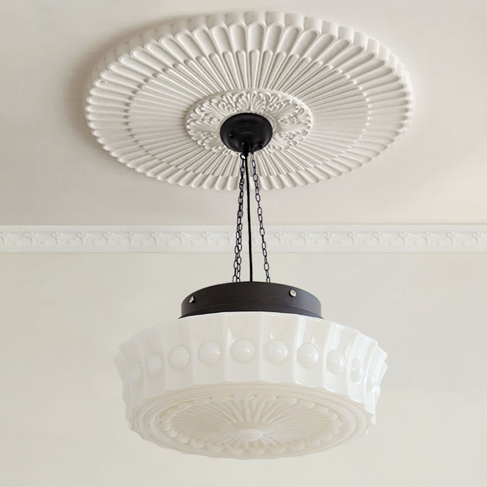 Clérachic scalloped glass dome pendant light hung on black chains beneath an ornate plaster ceiling rose in a cream panelled room