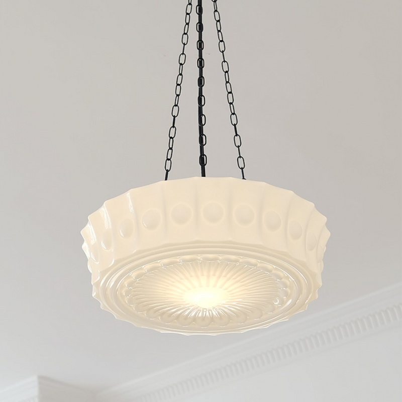 Looking up at the beige Clérachic scalloped glass dome pendant light, the bead-and-ray rosette in its base lit warm gold