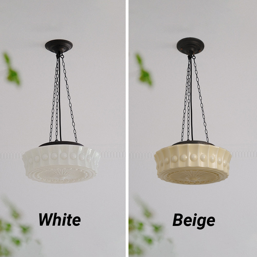 White and beige finishes of the Clérachic scalloped glass dome pendant light shown side by side, unlit, on a pale wall