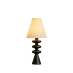 Black-based Clérachic table lamp with a lit white shade, shown whole on a plain white backdrop.