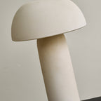 Close, tilted view of the unlit dome and the matt column, showing the speckled ceramic surface of this Clérachic table lamp.