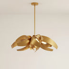 The same chandelier in the gold finish, every steel ribbon brushed gold inside and out, hanging from a single slim rod and round canopy