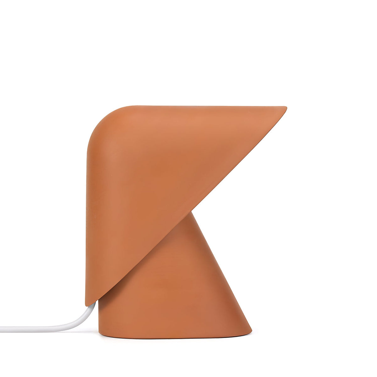 Orange Clérachic table lamp seen from slightly above, with the folded shade angled over a cone base, on a white backdrop.