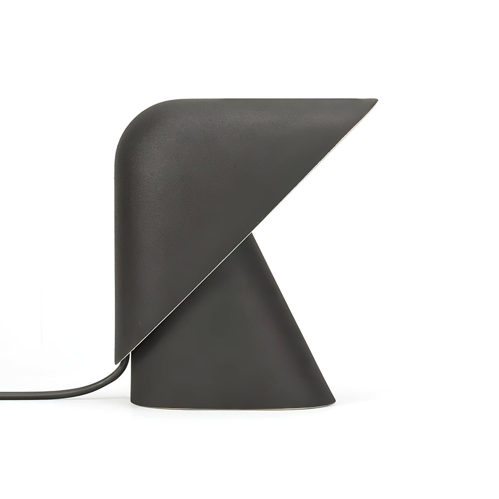 Black Clérachic table lamp on a white backdrop, with a matt finish, a folded shade over the cone base and a dark cord.