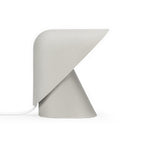 Grey Clérachic table lamp on a white backdrop, with a speckled matt finish, a folded shade and a white cord at the left.